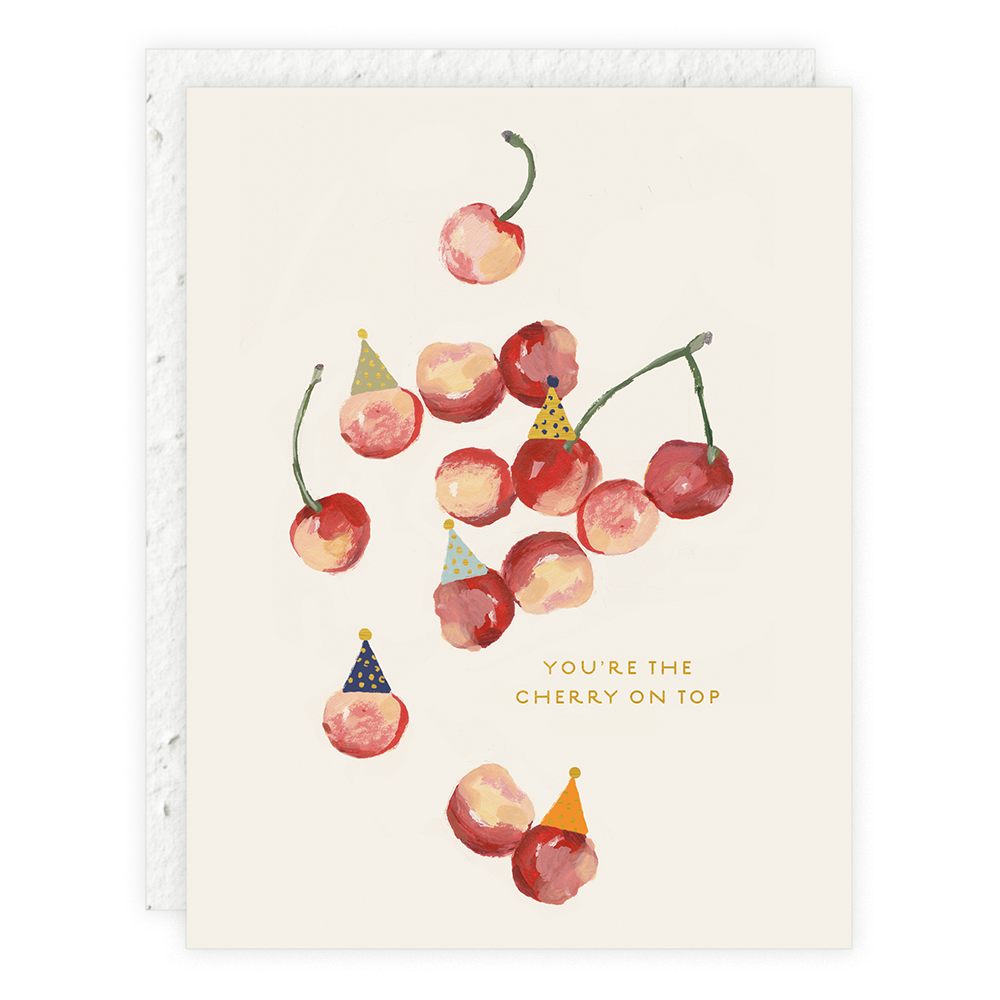 A greeting card with an illustration of cherries with birthday candles on top, alongside a textual message that reads 'You're the cherry on top'.