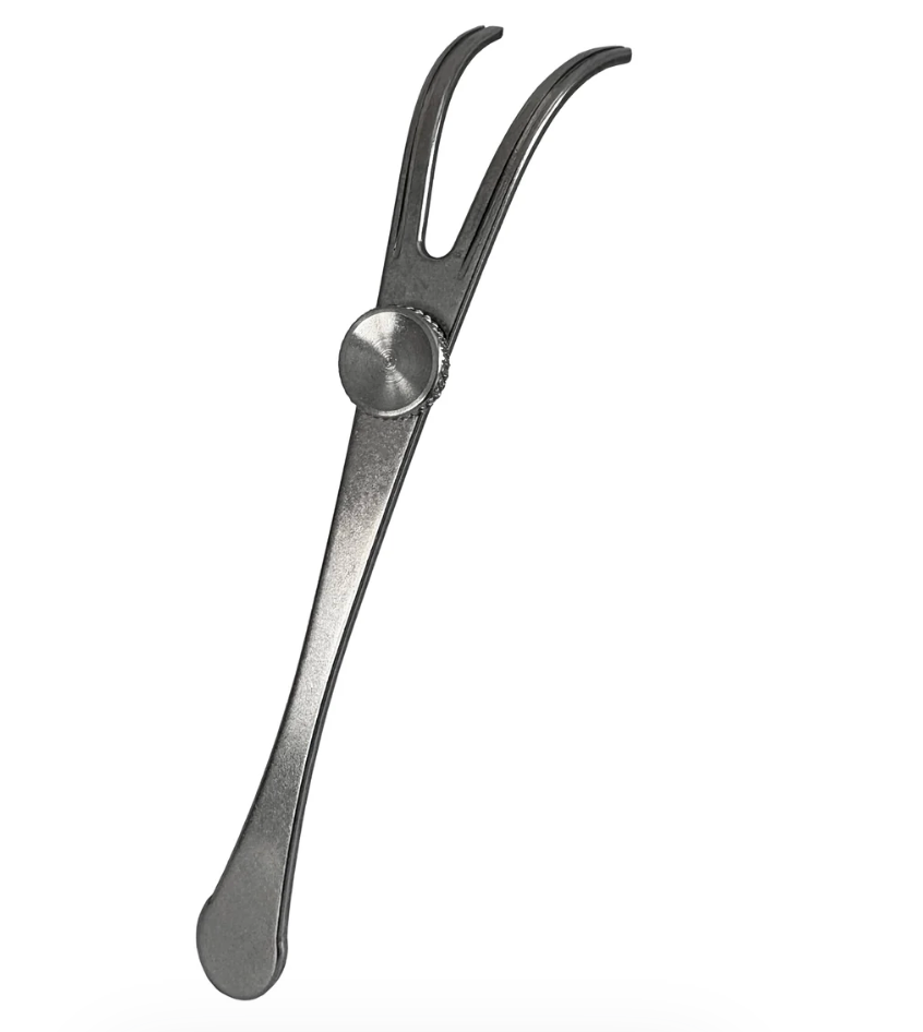 A dark gray metal double-pronged flosser tool with a circular pivot knob, shown on a plain white background.