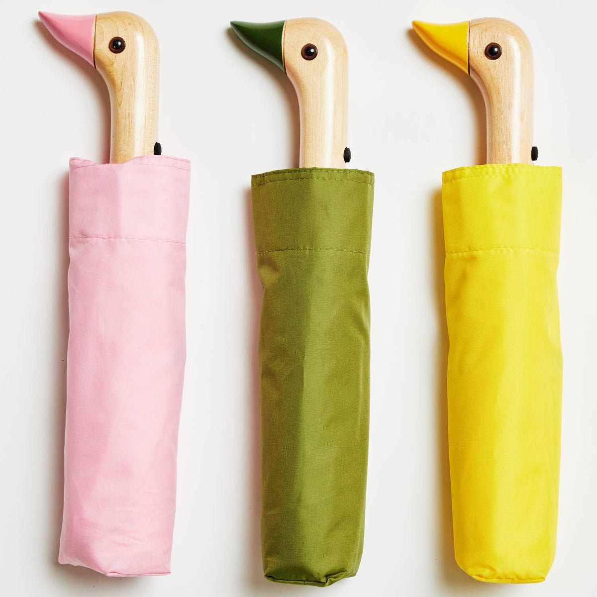 A collection of colorful umbrellas in various colors displayed in two rows, with wooden handles.