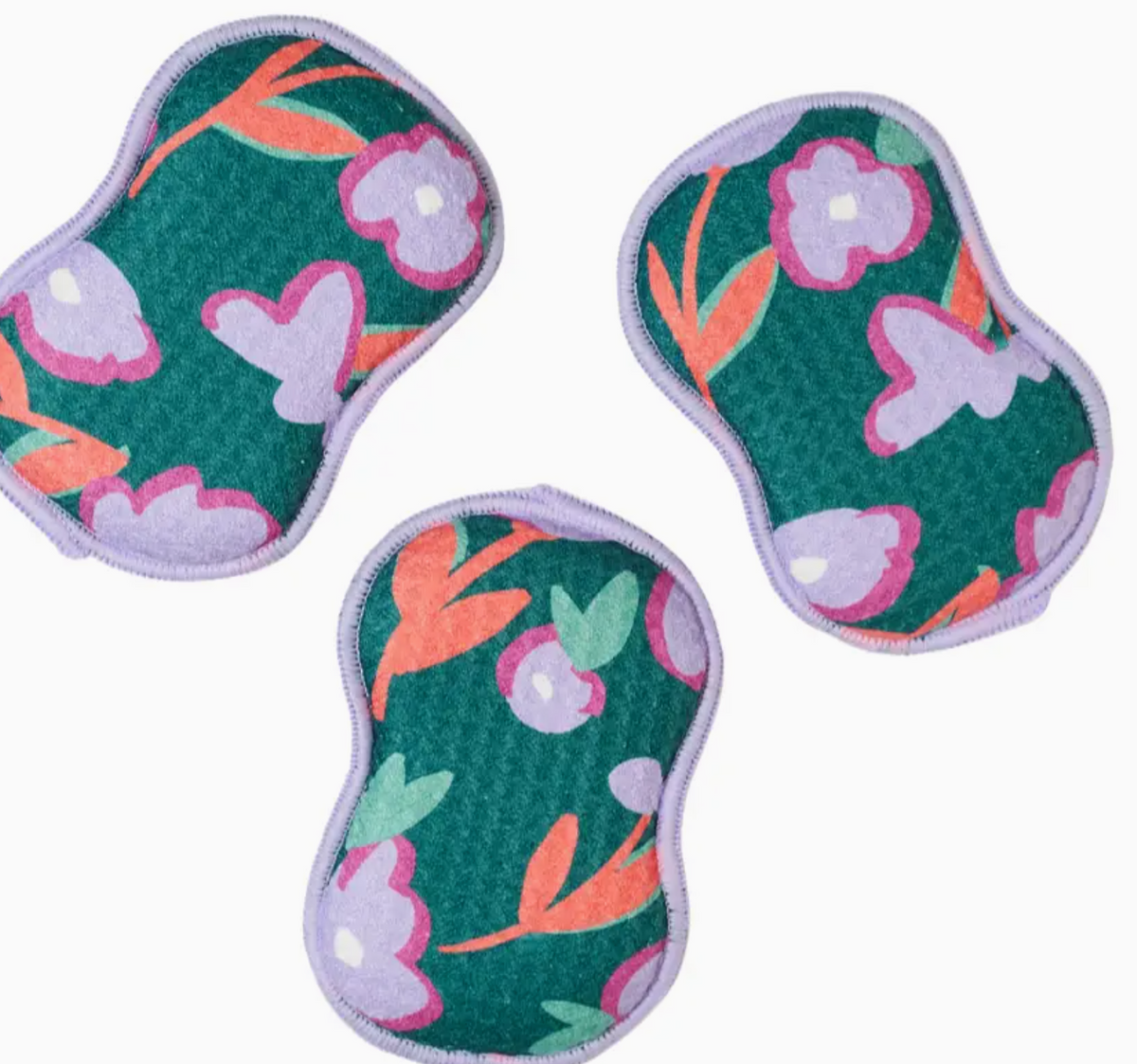 Three floral-patterned sponges on a white background